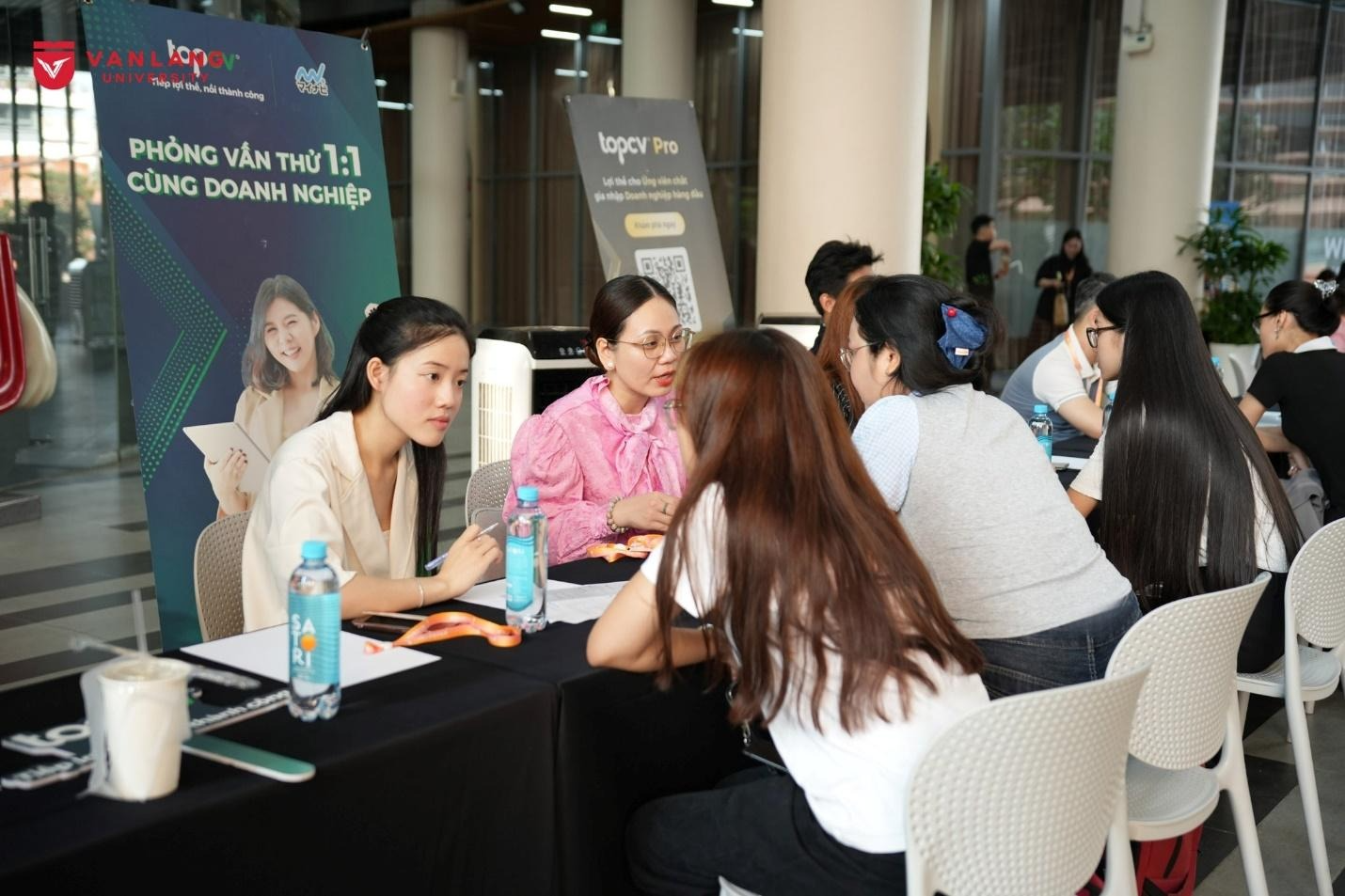 May be an image of one or more people, people studying, table and text
