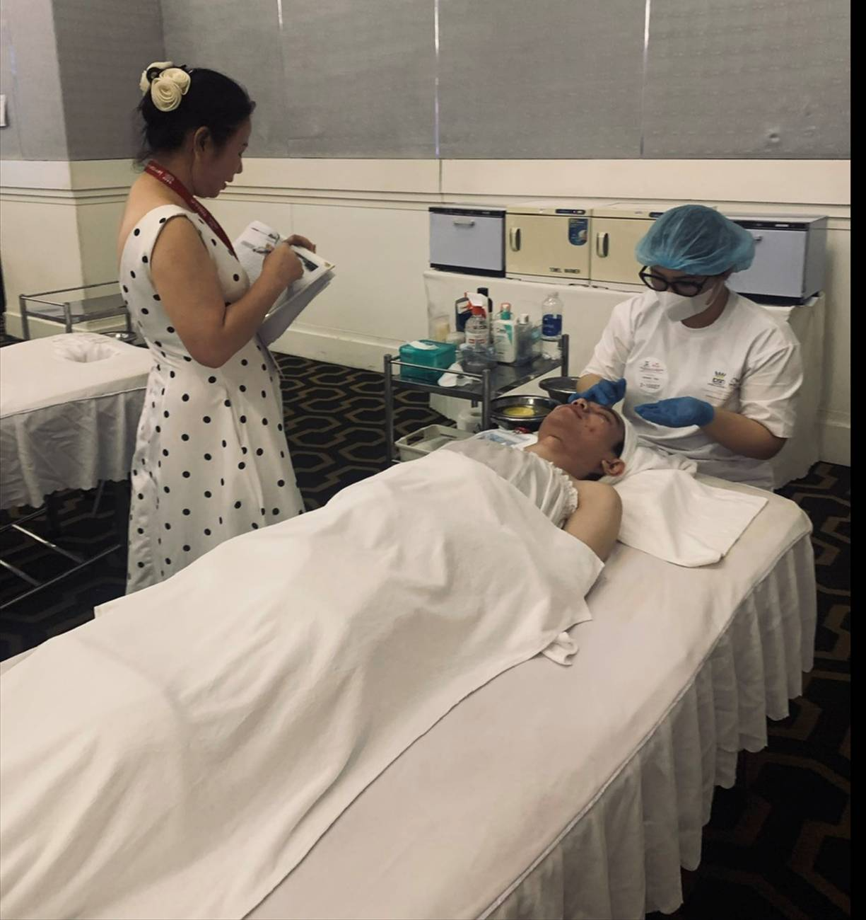 A person standing next to a person lying on a bed

AI-generated content may be incorrect.