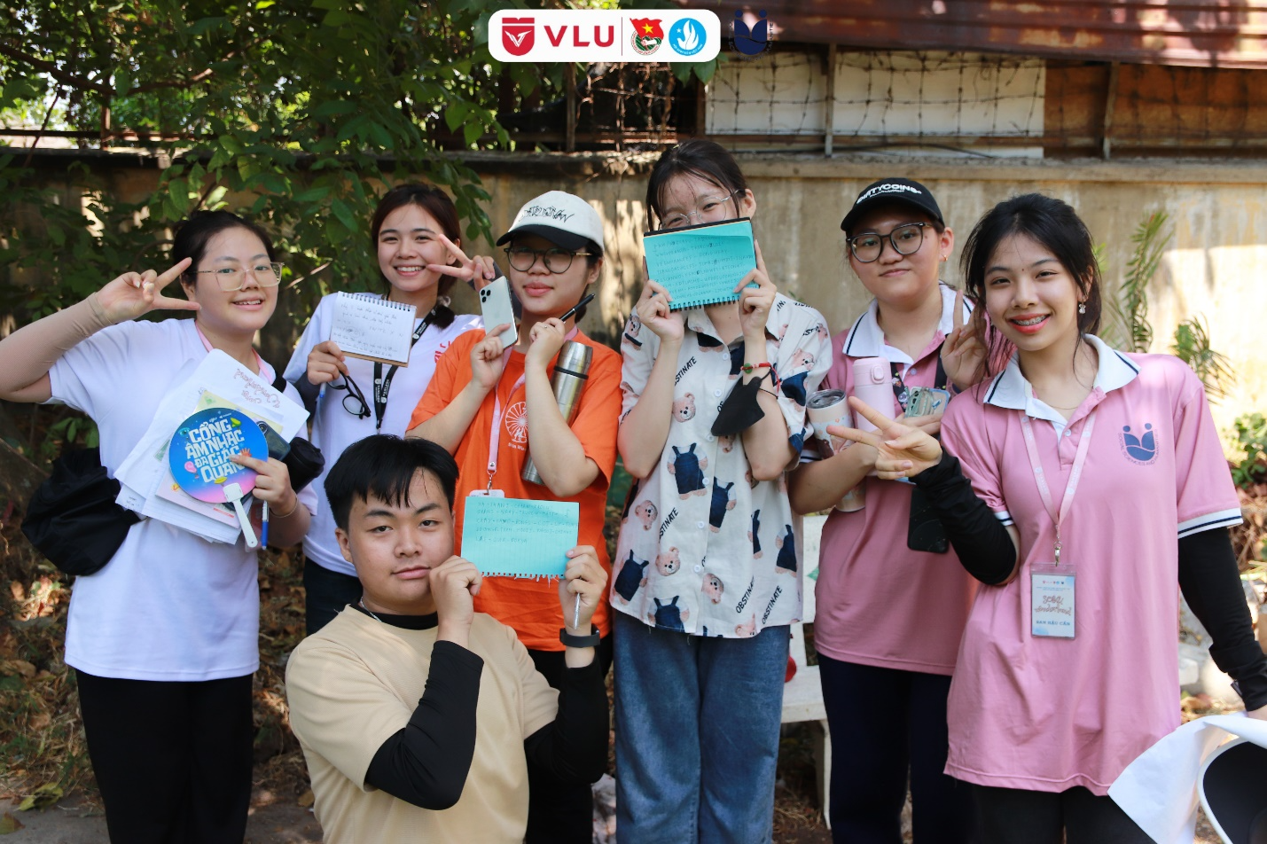 A group of people holding signs

Description automatically generated
